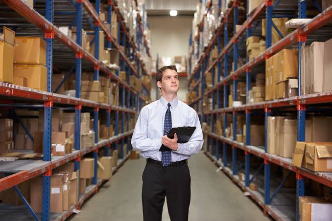 Suited man in warehouse