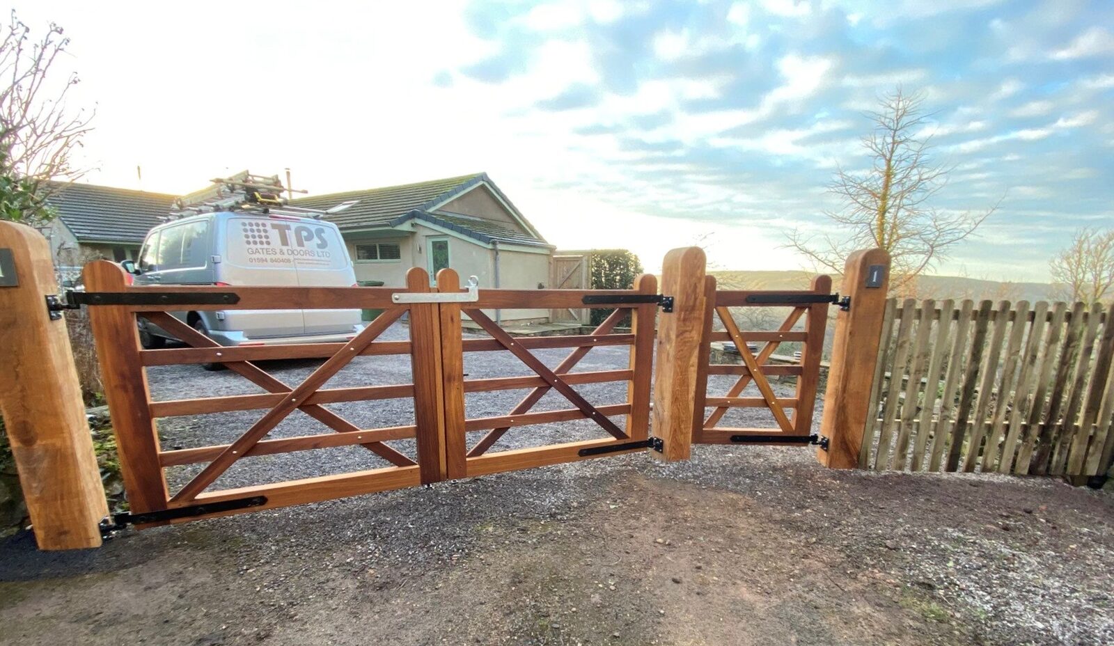 Oak five bar estate gates hung on oak posts at a field entrance